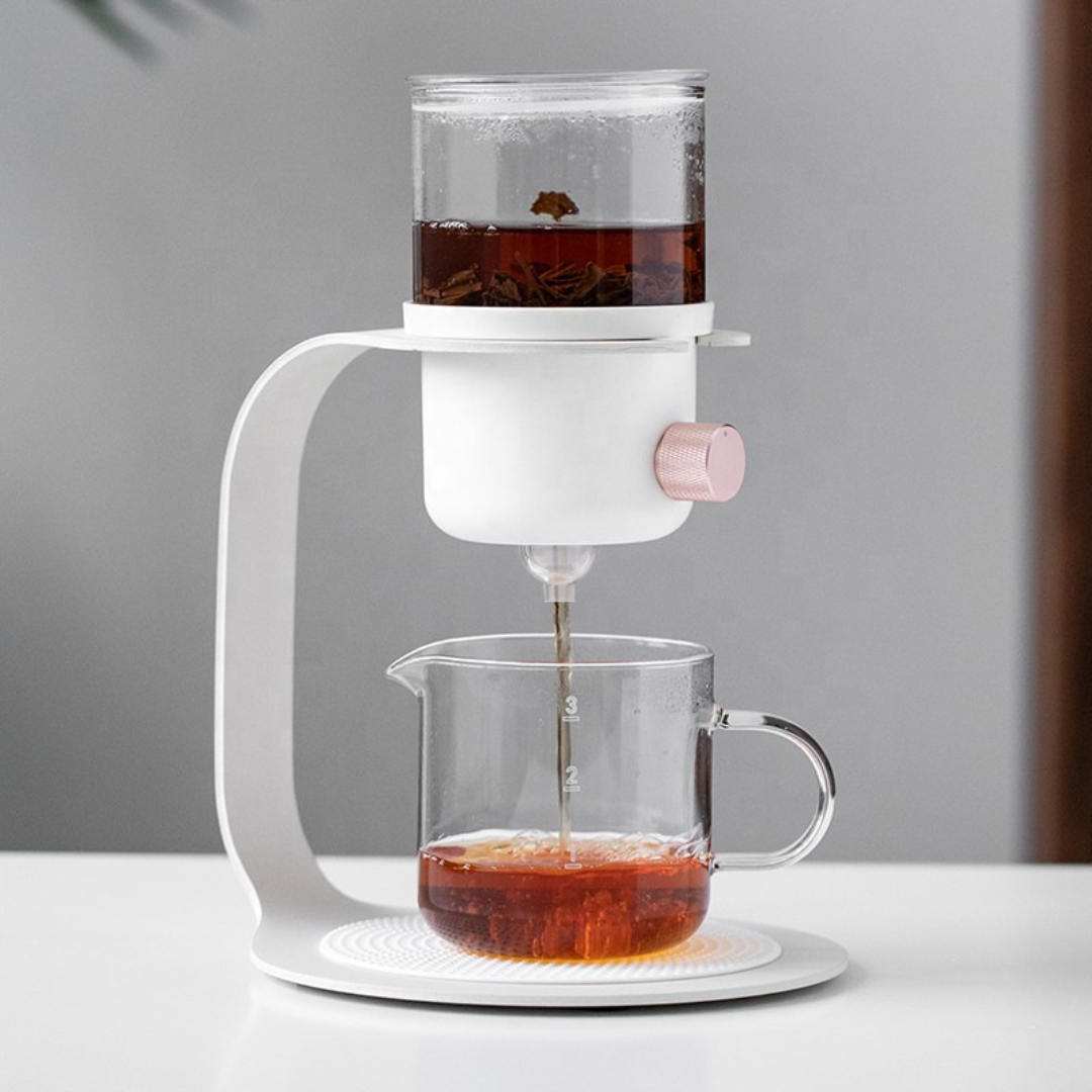 Tea pouring from a modern white glass teapot