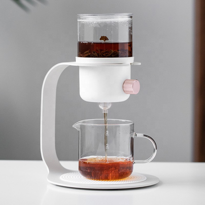 Tea pouring from a modern white glass teapot