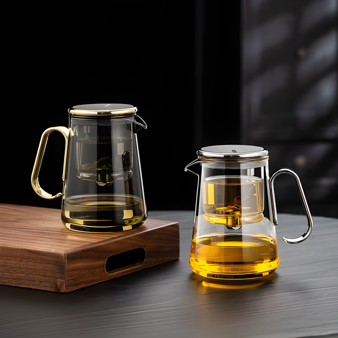 Side by side gold and silver clear glass teapots